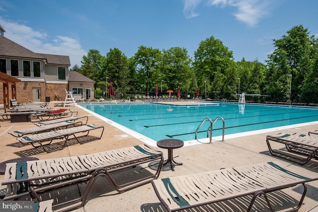 6110 Joust Ln, Alexandria, VA 22315 - community pool with a patio area and view of scattered trees