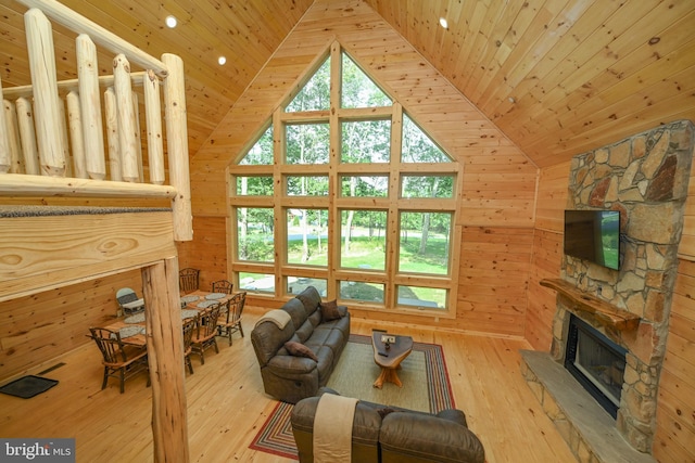 118 Sandstone, Mc Henry, MD 21541 - living room with wood ceiling, wooden walls, a stone fireplace, hardwood / wood-style floors, and high vaulted ceiling
