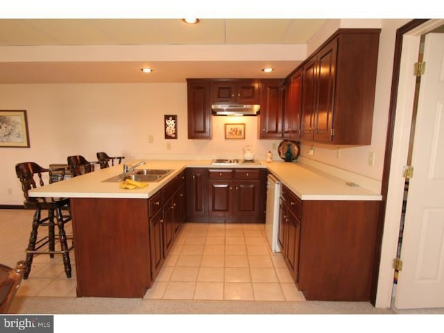 540 Hain Rd, Sinking Spring, PA 19608 - kitchen with under cabinet range hood, a peninsula, a kitchen bar, light countertops, and recessed lighting