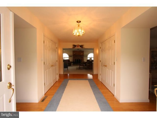 540 Hain Rd, Sinking Spring, PA 19608 - hallway with light wood-style flooring and a chandelier