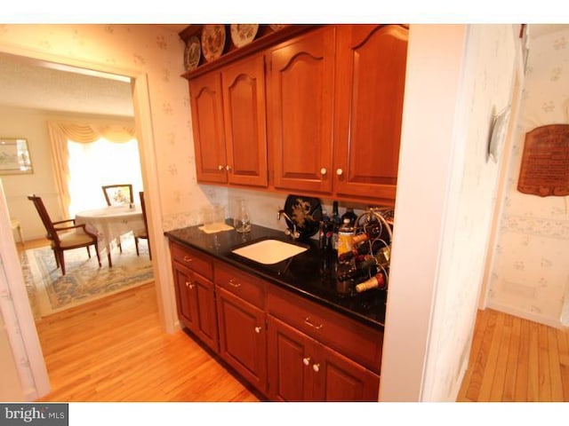 540 Hain Rd, Sinking Spring, PA 19608 - kitchen featuring wallpapered walls, light wood-type flooring, and dark countertops