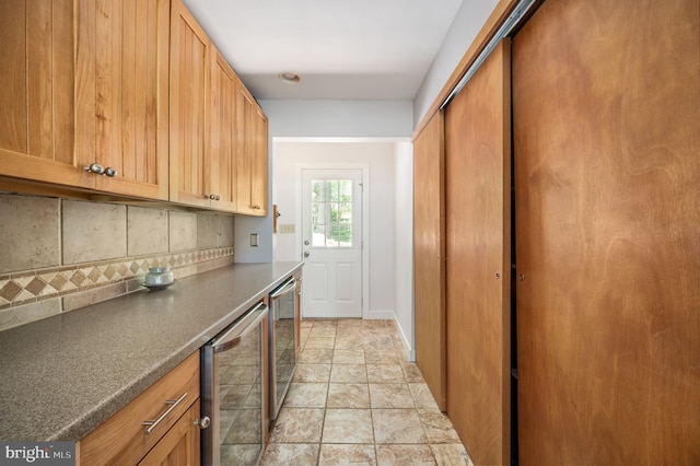 15 Tally Ho Dr, Fredericksburg, VA 22405 - kitchen with beverage cooler, decorative backsplash, dark countertops, and light stone finish flooring