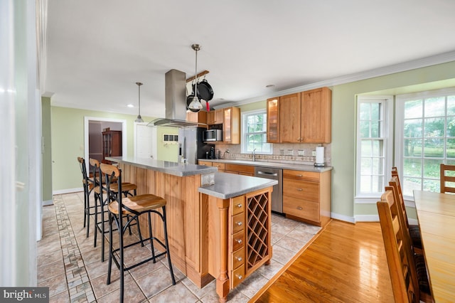15 Tally Ho Dr, Fredericksburg, VA 22405 - kitchen with island exhaust hood, stainless steel appliances, ornamental molding, a kitchen island, and a kitchen bar