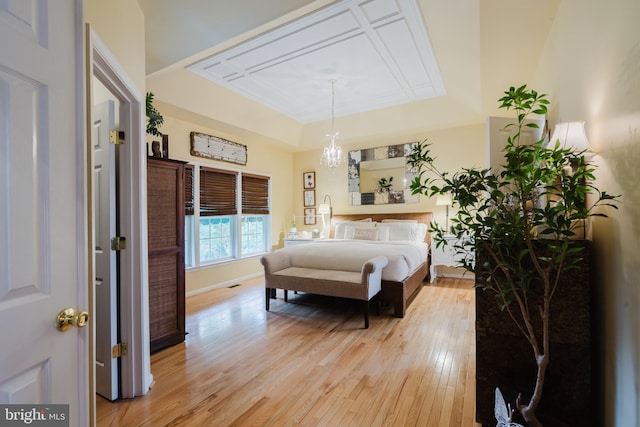 56 Willow Grove Mill Dr, Middletown, DE 19709 - bedroom featuring a raised ceiling, light wood finished floors, and a chandelier