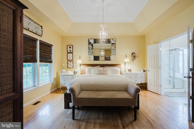 56 Willow Grove Mill Dr, Middletown, DE 19709 - bedroom with a raised ceiling, light wood finished floors, and a chandelier