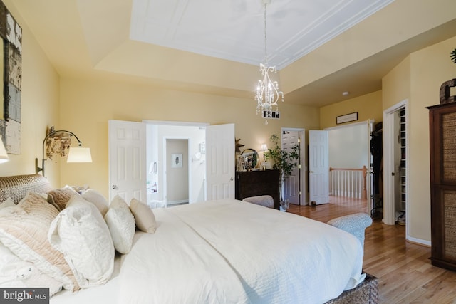 56 Willow Grove Mill Dr, Middletown, DE 19709 - bedroom featuring wood finished floors, a raised ceiling, and a chandelier