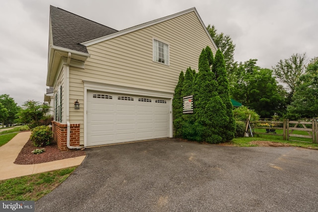 56 Willow Grove Mill Dr, Middletown, DE 19709 - view of side of home with roof with shingles, driveway, an attached garage, and brick siding