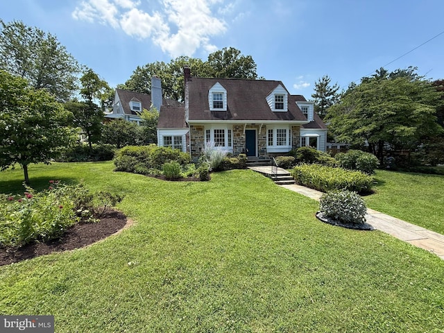 898 N Kentucky St, Arlington, VA 22205 - cape cod home with stone siding, a front lawn, and a chimney