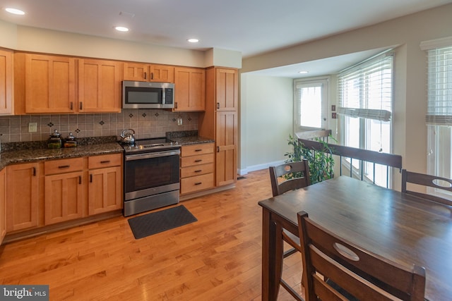 615 Society Hill Blvd, Cherry Hill, NJ 08003 - kitchen with appliances with stainless steel finishes, light wood-style floors, tasteful backsplash, recessed lighting, and dark stone counters