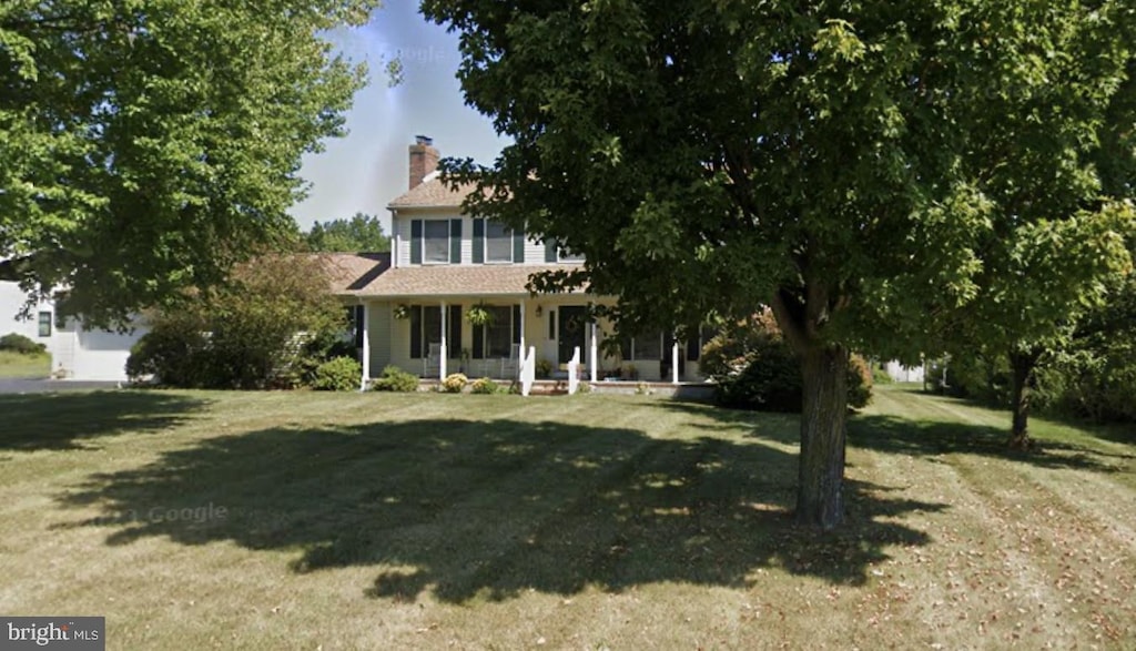511 Chesterfield Arneytown Rd, Chesterfield, NJ 08515 - view of front of home featuring covered porch, a front lawn, and a chimney
