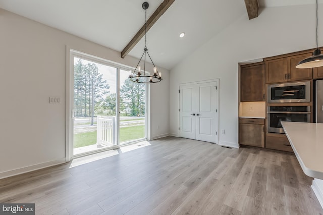 168 Tall Oak Dr, Felton, DE 19943 - kitchen featuring appliances with stainless steel finishes, beam ceiling, a chandelier, light countertops, and high vaulted ceiling