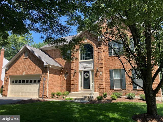 3007 Viburnum Pl, Olney, MD 20842 - traditional-style house with an attached garage, a front lawn, brick siding, and driveway