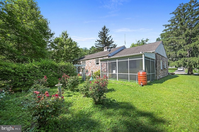 609 Apple Rd, Newark, DE 19711 - back of house featuring a sunroom, a yard, a shingled roof, and brick siding
