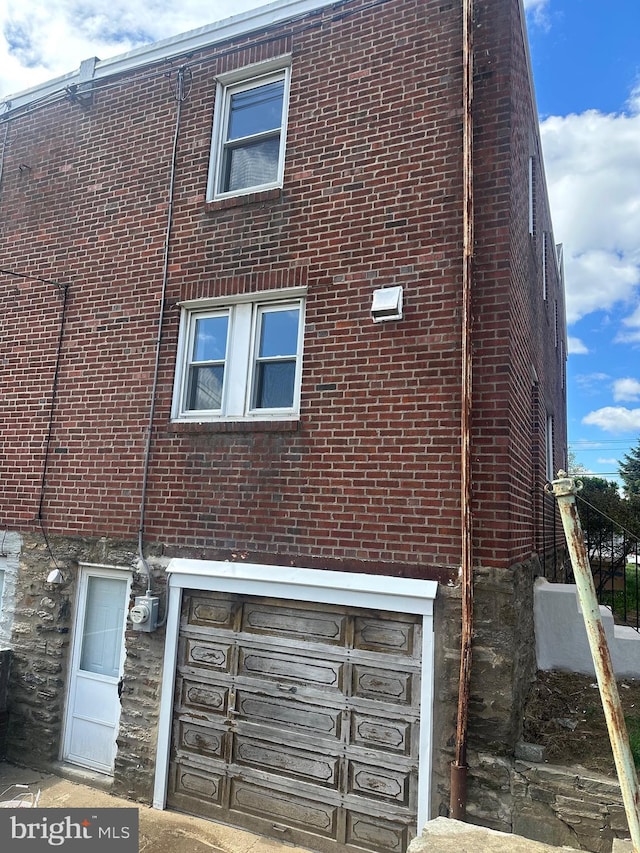1333 Friendship St, Philadelphia, PA 19111 - view of home's exterior with brick siding, an attached garage, and stone siding