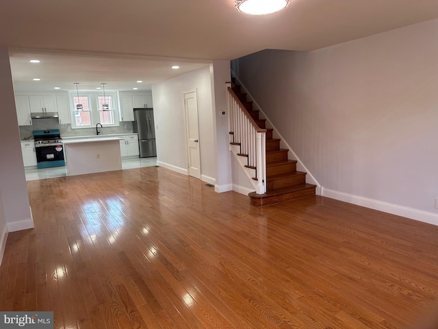 1333 Friendship St, Philadelphia, PA 19111 - unfurnished living room with light wood-style floors, stairs, and recessed lighting