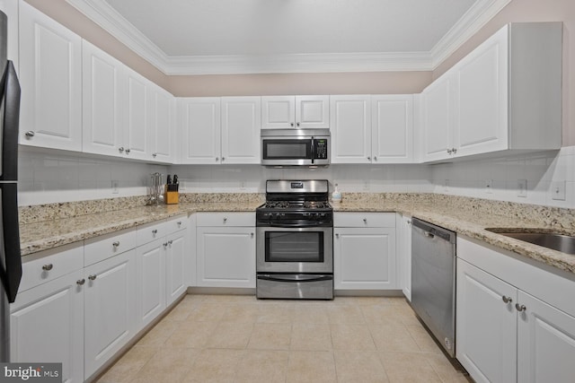 7 Booth St Unit 202, Gaithersburg, MD 20878 - kitchen with stainless steel appliances, crown molding, white cabinetry, light tile patterned floors, and light stone counters
