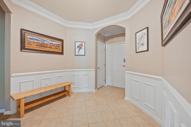 7 Booth St Unit 202, Gaithersburg, MD 20878 - hall with ornamental molding, arched walkways, a wainscoted wall, light tile patterned floors, and a decorative wall