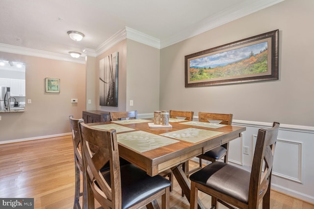7 Booth St Unit 202, Gaithersburg, MD 20878 - dining area featuring light wood finished floors and ornamental molding