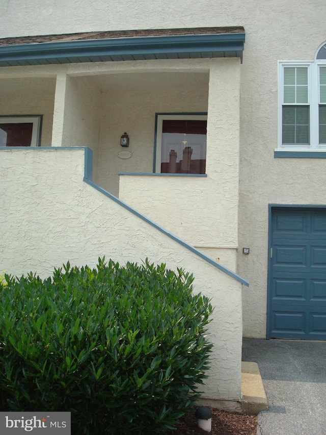 1704 Stoneham Dr, West Chester, PA 19382 - view of exterior entry with stucco siding and a garage
