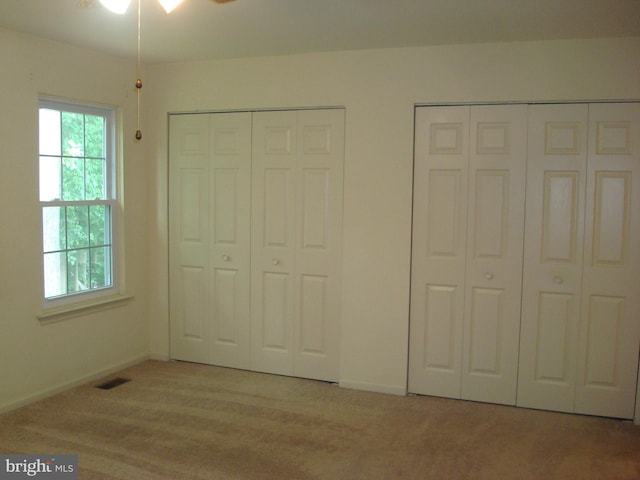 1704 Stoneham Dr, West Chester, PA 19382 - unfurnished bedroom featuring multiple closets and light carpet