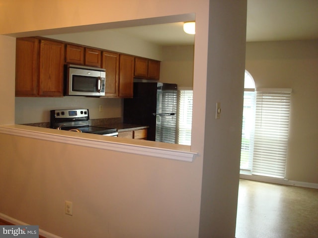 1704 Stoneham Dr, West Chester, PA 19382 - kitchen with stainless steel appliances, brown cabinets, and dark countertops