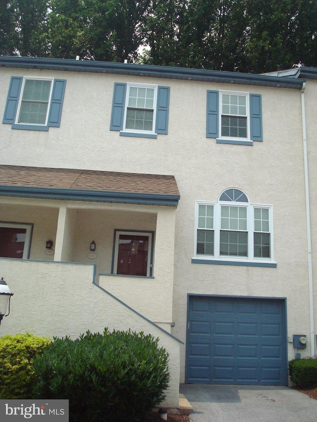 1704 Stoneham Dr, West Chester, PA 19382 - townhome / multi-family property with a garage, stucco siding, and driveway