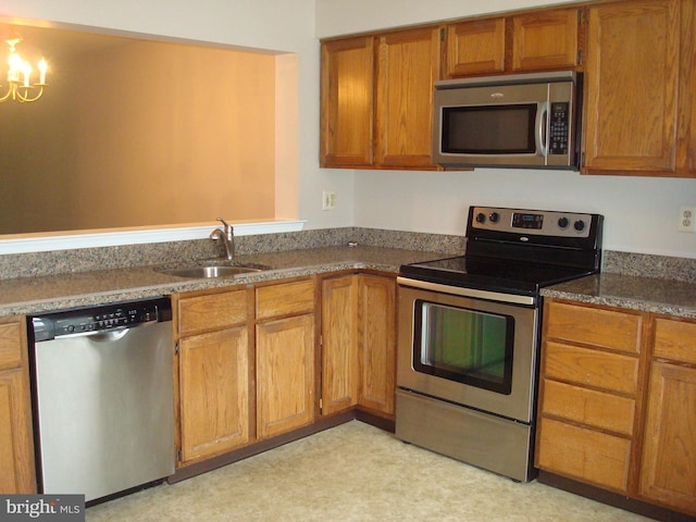 1704 Stoneham Dr, West Chester, PA 19382 - kitchen with stainless steel appliances, brown cabinets, and a chandelier
