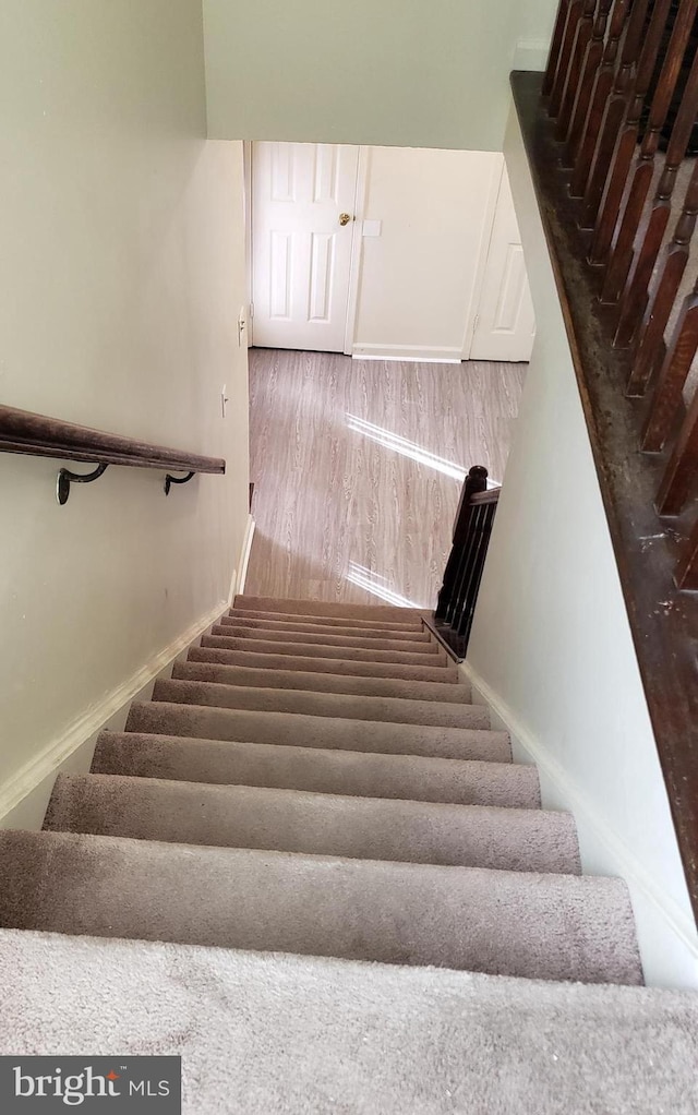 15021 Mcknew Rd, Burtonsville, MD 20866 - stairway featuring baseboards and wood finished floors