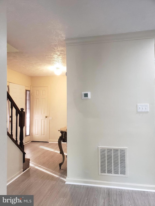 15021 Mcknew Rd, Burtonsville, MD 20866 - entryway with wood finished floors, a textured ceiling, and stairs