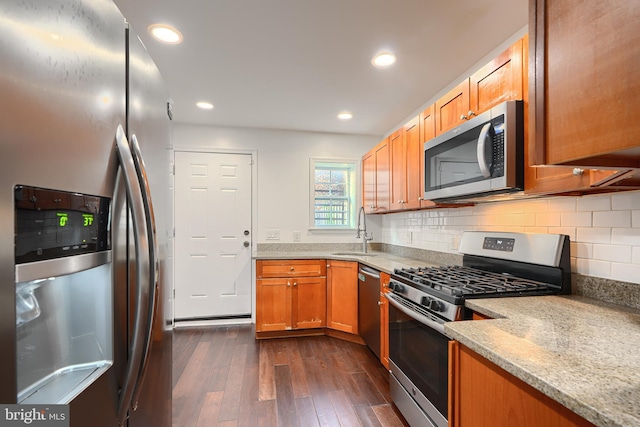 930 Washington Blvd, Baltimore, MD 21230 - kitchen with appliances with stainless steel finishes, dark wood-style floors, tasteful backsplash, recessed lighting, and light stone countertops