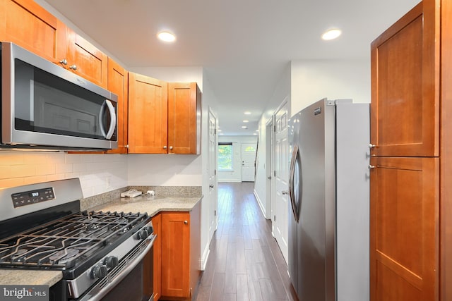 930 Washington Blvd, Baltimore, MD 21230 - kitchen with appliances with stainless steel finishes, dark wood-type flooring, decorative backsplash, recessed lighting, and light stone counters