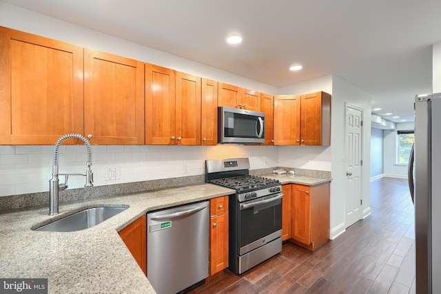930 Washington Blvd, Baltimore, MD 21230 - kitchen featuring stainless steel appliances, dark wood-style floors, light stone counters, decorative backsplash, and recessed lighting