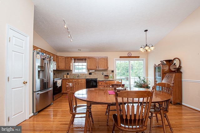 75 Westminster Dr, Front Royal, VA 22630 - kitchen with appliances with stainless steel finishes, vaulted ceiling, light wood finished floors, a textured ceiling, and backsplash