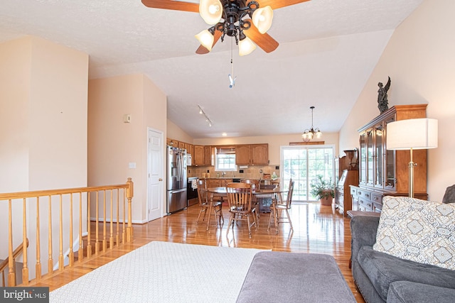 75 Westminster Dr, Front Royal, VA 22630 - living area with lofted ceiling, a ceiling fan, light wood finished floors, and a chandelier