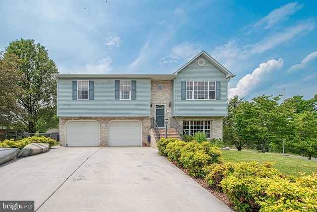 75 Westminster Dr, Front Royal, VA 22630 - split foyer home with concrete driveway, an attached garage, and brick siding