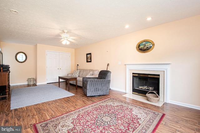 75 Westminster Dr, Front Royal, VA 22630 - living area featuring a ceiling fan, wood finished floors, a textured ceiling, a fireplace with flush hearth, and recessed lighting