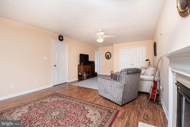 75 Westminster Dr, Front Royal, VA 22630 - living area featuring a fireplace, a ceiling fan, wood finished floors, and a textured ceiling