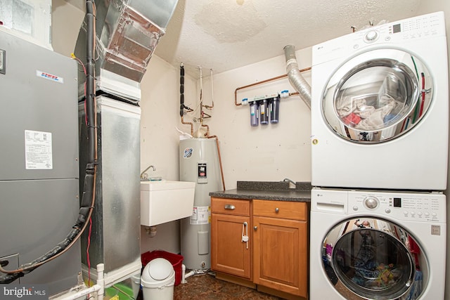 75 Westminster Dr, Front Royal, VA 22630 - laundry area featuring stacked washer / drying machine, water heater, cabinet space, heating unit, and a textured ceiling