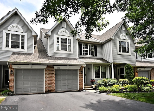 1015 Greenes Way Cir, Collegeville, PA 19426 - townhome / multi-family property with brick siding, driveway, roof with shingles, and a garage