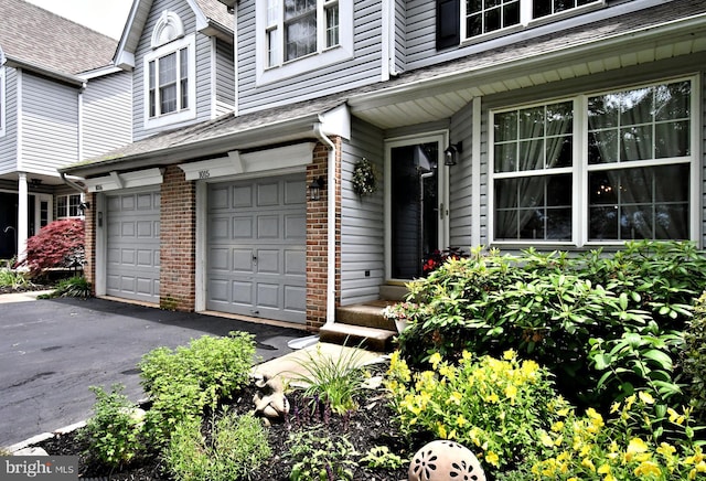 1015 Greenes Way Cir, Collegeville, PA 19426 - entrance to property with an attached garage, brick siding, driveway, and a shingled roof