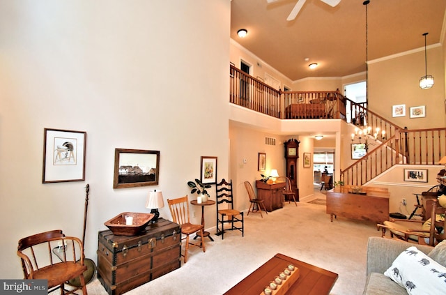 1015 Greenes Way Cir, Collegeville, PA 19426 - living room with carpet floors, ornamental molding, a towering ceiling, stairway, and ceiling fan