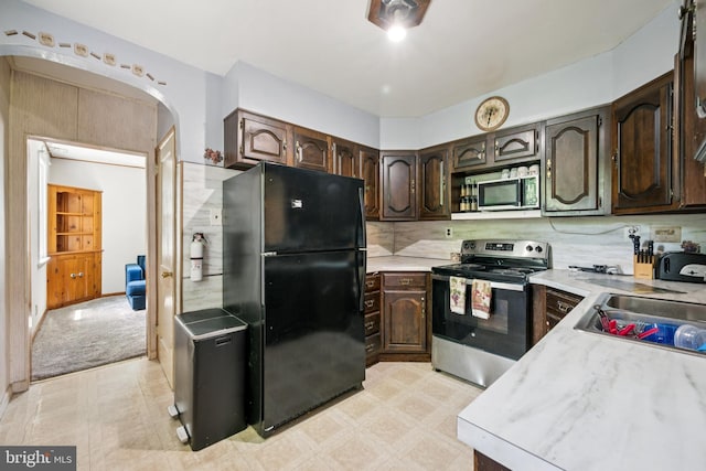 515 N Walnut Ave, Magnolia, NJ 08049 - kitchen with appliances with stainless steel finishes, light countertops, dark brown cabinets, light floors, and decorative backsplash