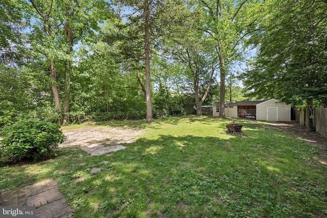 515 N Walnut Ave, Magnolia, NJ 08049 - fenced backyard featuring a storage shed and an outdoor fire pit