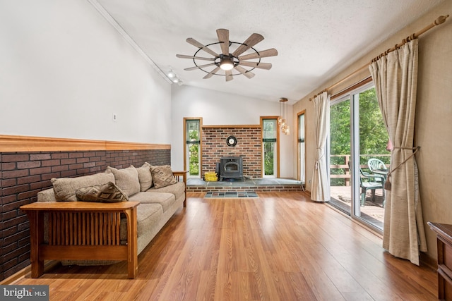 515 N Walnut Ave, Magnolia, NJ 08049 - living room featuring a wood stove, ceiling fan, light wood-type flooring, lofted ceiling, and ornamental molding
