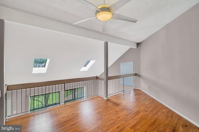 22 Witch Hazel Ct, Monmouth Junction, NJ 08852 - spare room with a skylight, wood finished floors, a ceiling fan, and a textured ceiling