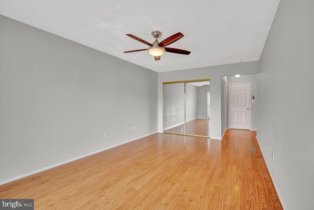 22 Witch Hazel Ct, Monmouth Junction, NJ 08852 - unfurnished bedroom featuring a closet, light wood finished floors, a textured ceiling, and a ceiling fan