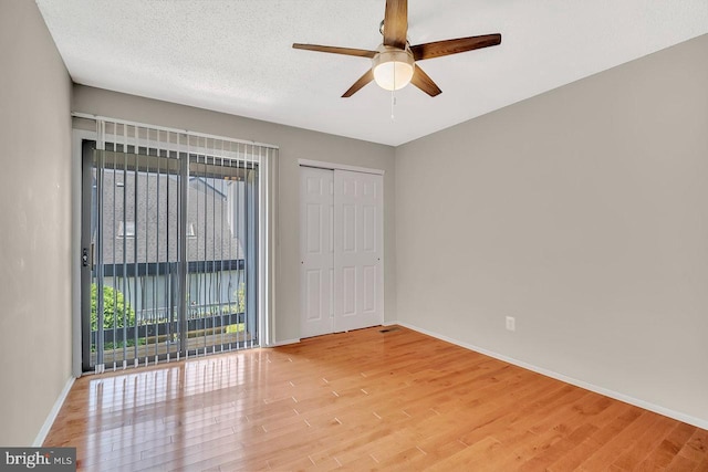 22 Witch Hazel Ct, Monmouth Junction, NJ 08852 - unfurnished bedroom featuring light wood-style floors, ceiling fan, a closet, and access to exterior