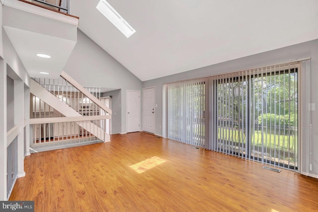22 Witch Hazel Ct, Monmouth Junction, NJ 08852 - unfurnished living room with high vaulted ceiling, wood finished floors, a skylight, and stairway