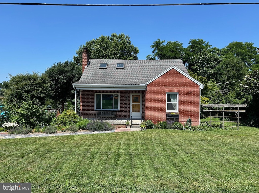 867 Elm St, Bressler, PA 17113 - view of front facade with brick siding, a front lawn, a porch, and a chimney
