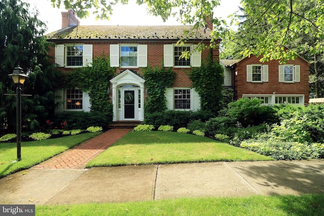 320 Hartswick Ave, State College, PA 16803 - view of front of home with brick siding, a front lawn, and a chimney